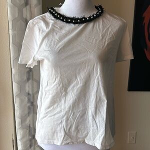 Top with some tweed details and pearls